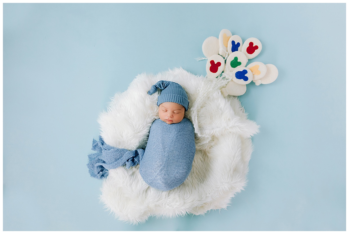 The Perfect Age for Newborn Photos: What You Need to Know - Disney Newborn Photography ideas and inspiration by White Rabbit Photo Boutique