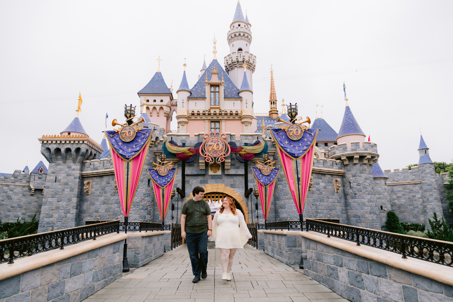 Disneyland engagement session with candid moments at sleeping beautys castle