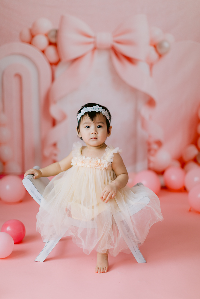 Pink and bows cake smash session at a Santa Ana photography studio