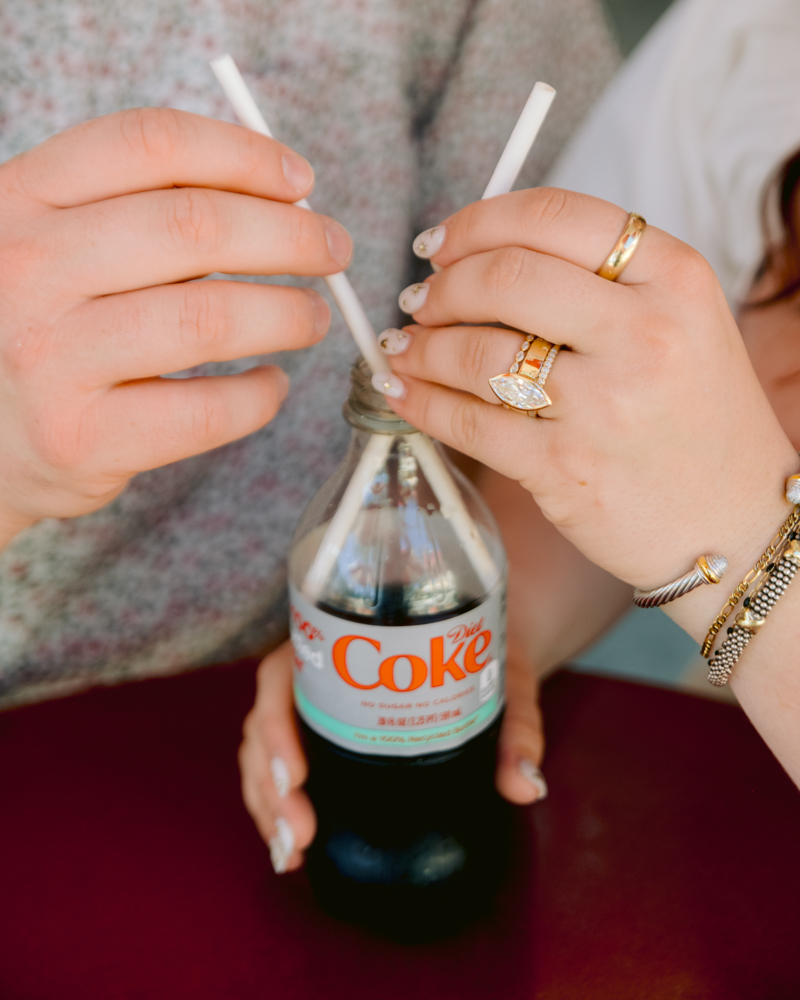 Disneyland engagement photos with Coca-Cola bottle and classic snacks and churros